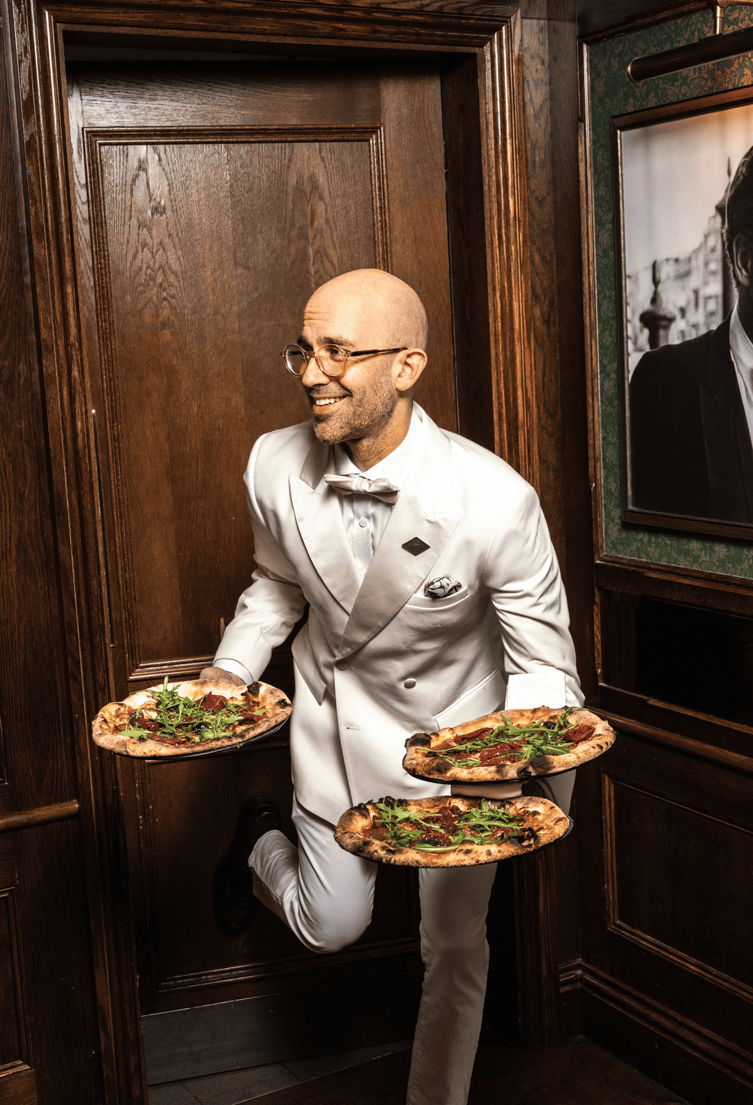 waiter serving pizza at Harry's Victoria